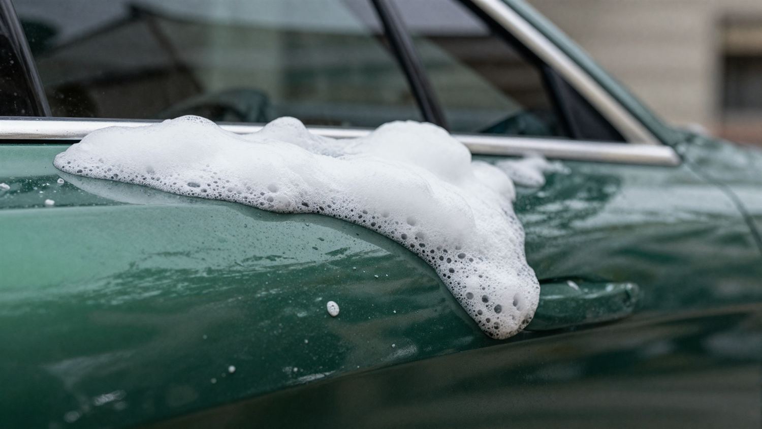 A sedan being hand washed
